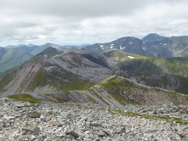 View west from Stob Choire Claurigh. Sgurr Choinich Mor is the dark looking double peak below the skyline. Aonach Beag and Ben Nevis tower over in the distance. Photo https://big-gorse-bush.blogspot.com/